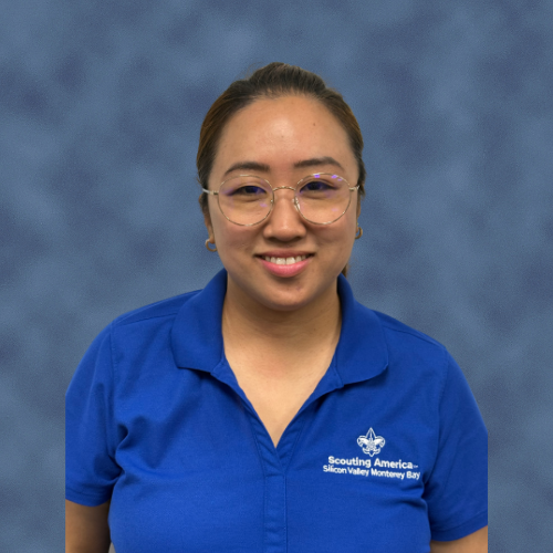 A person wearing a blue polo shirt with "Scouting America - Silicon Valley Monterey Bay" embroidered on it.