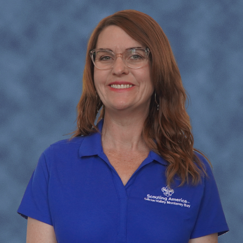 A person is wearing a blue shirt with a logo related to Scouting America.