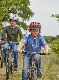 Cub Scouts riding bicycles in the park