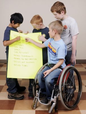 Scouts going over meeting agenda - One scout in wheelchair