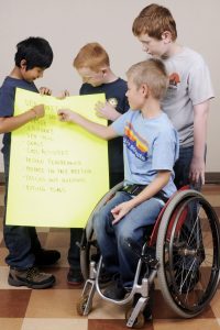 Scouts going over meeting agenda - One scout in wheelchair